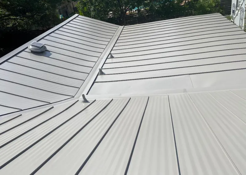 Solar attic fan installed on a metal roof for Roof Ventilation in Silvis